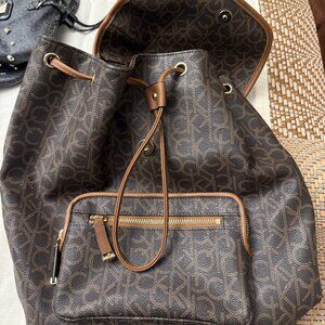 Calvin Klein Signature Monogram Drawstring Backpack – Brown